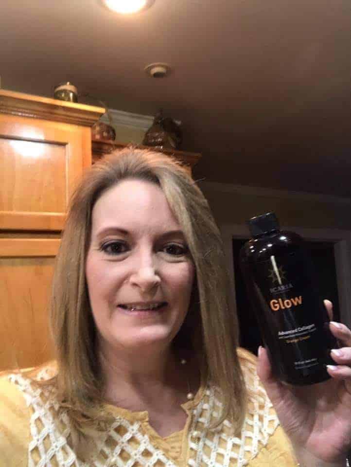 Lady holding up her favorite product Glow liquid collagen