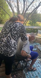 picture of a women trimming a man's hair