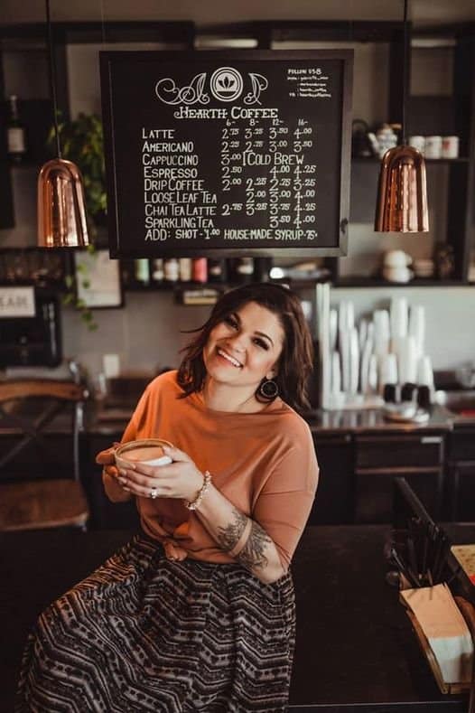 lady sitting in a coffee shop enjoying her new Mojo coffee replacement
