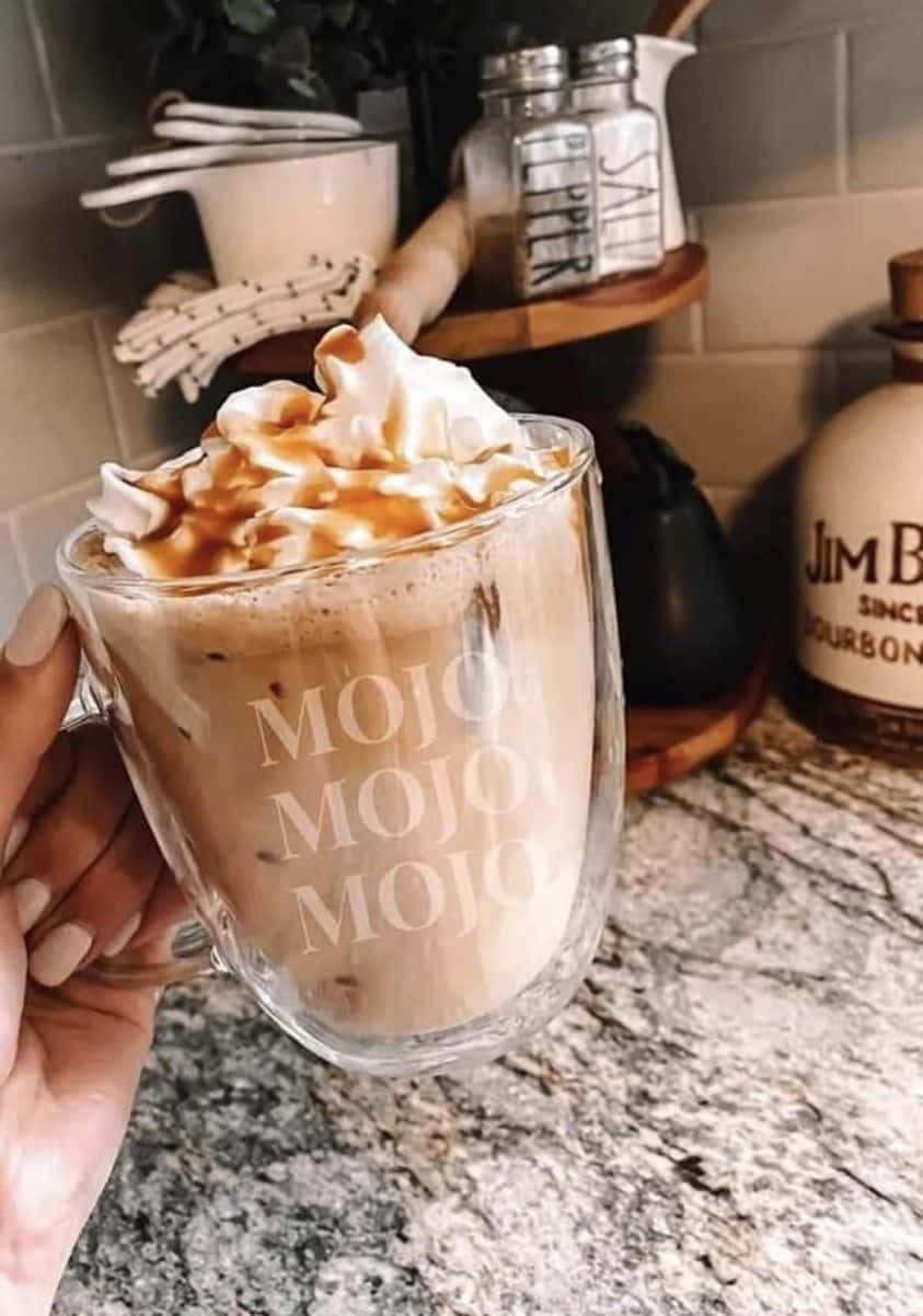 Picture of a cup of Mojo coffee replacement with whipped cream & caramel sauce