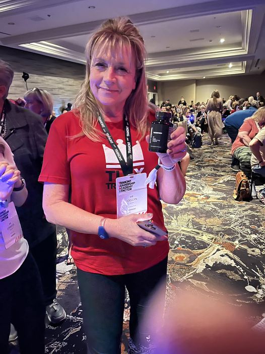 photo of a woman holding up a bottle of Transform