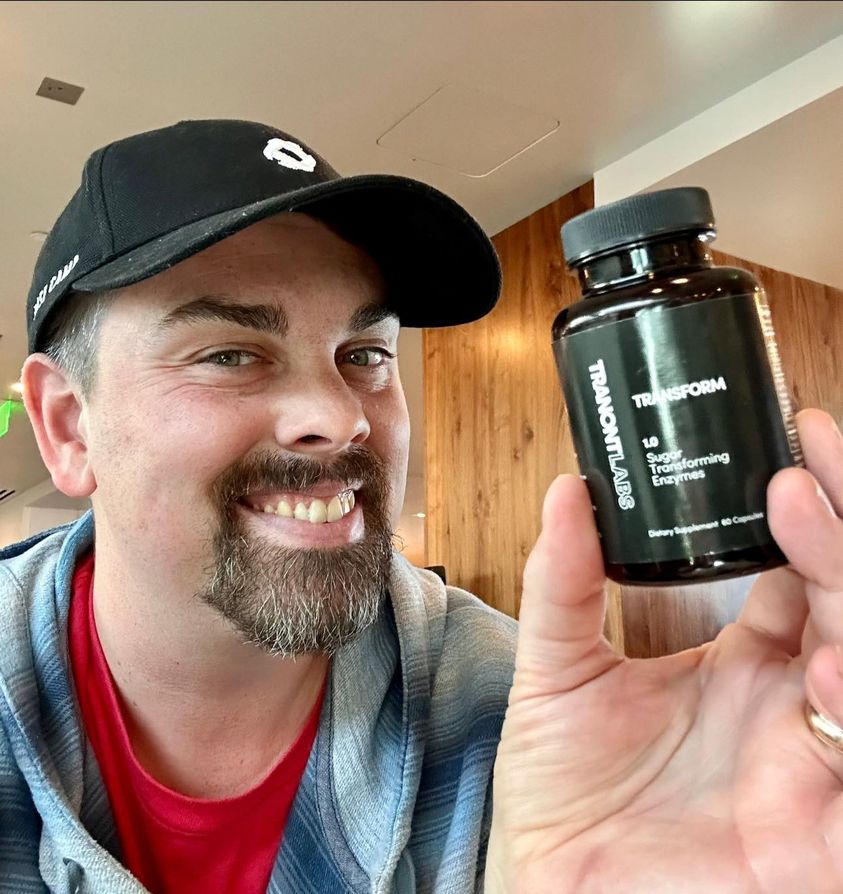 A man holding up our plant enzyme Transform