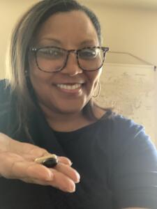 A woman holding out Renew & Balance pills in her hand