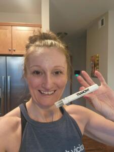 A very happy woman holding up Suthe CBD spray