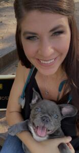 A photo of a woman holding a puppy dog